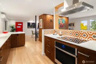 The remodeled kitchen is an instant showcase for this home’s midcentury style; find updated high end appliances, quartz counters, soft close drawers and graphic tile details.