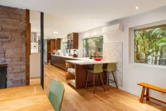 Looking back at the kitchen from the dining room shows extra seating and the mini split which provides AC and heat.