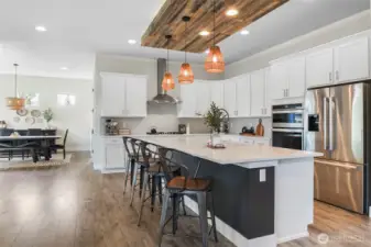 Quartz counters, soft close drawers, accent ceiling above huge island