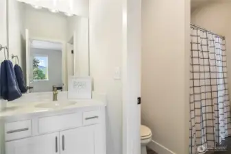 Upper level bedroom with access to bathroom; other vanity area accessed from open living area