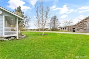 View looking across the dead-end street, imagine rocking on your country front porch & looking at that rustic barn & pastureland beyond
