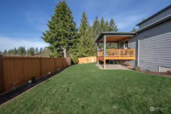 Unwind in the serenity of this spacious, fenced backyard.