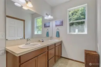 Primary bathroom with double vanity, large walk in shower, walk in closet and linen closet