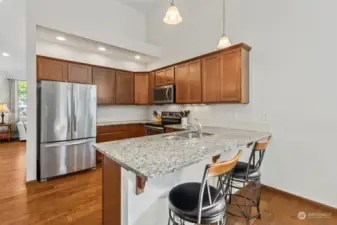 Kitchen with maple cabinets, stainless appliances, granite counters. Electric cooking.