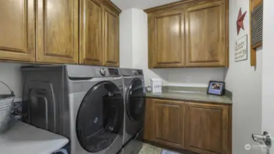 A dedicated laundry room featuring a washer and dryer for ultimate convenience