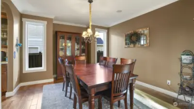 Elegant dining space featuring a minimalist chandelier, perfect for intimate gatherings.