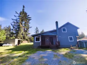 Back of the house with more parking spaces