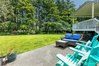 Relax on the patio while enjoying the serene setting of the backyard.