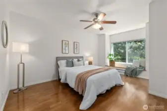 The spacious primary bedroom is both private and sun-filled.