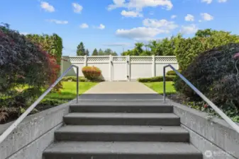 Exit to the common green space area, alley and garbage/recycling receptacles.