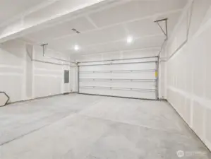 11: Spacious two-car alley-load garage is fully drywalled and brightly lit—ready for parking, storage, or workshop projects. Pictures are for representational purposes only, colors and features may vary.