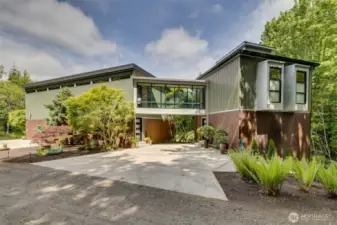 Idyllic Camano Retreat on 10 acres with Sweeping Mt Baker and Utsalady Bay views. Modern 2007 built two story plus basement, with dramatic contemporary lines and unique finishes with concrete floors, some copper backsplash and wainscot and high ceilings, lots of windows & light, skybridge walkway to primary suite. Total privacy! Lots of wildlife including a local herd of deer. Convenient North End location with EZ access to Stanwood and I-5. Main house with dbl garage + office+ shop with 1 bedroom & 1 bath space above shop.
