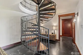 Interior spiral stairway and concrete floors. Very custom and beautiful!
