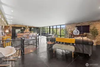 Beautiful open space design with lots of windows and light. Notice the beautiful floors and copper accents, lots of stone on the wall.