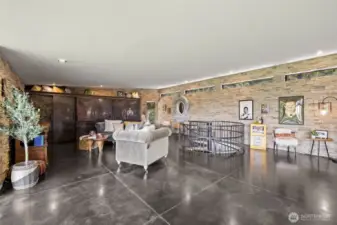 From dining area looking towards living rm. Custom shelving unit at the end of the room with antiqued metal doors