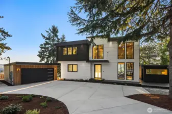 Modern curb appeal – A bold façade with sleek lines, circular driveway, and striking architecture that makes a lasting first impression.