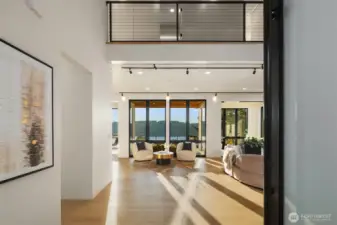 Welcoming arrival – Step inside to soaring ceilings and walls of glass framing Lake Washington.