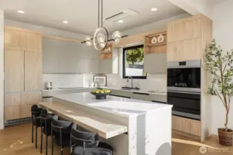 Culinary centerpiece – An oversized island invites gathering and gourmet cooking.