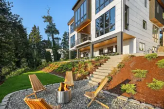 Gather outdoors – Step down to a firepit framed by lush landscaping and endless conversation under the open sky.
