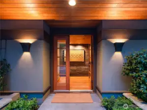 An elegant entryway offers a warm welcome into the home's storied elegance