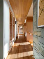 Hallway with Australian gum wood floors leads into the heart of the home