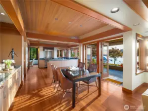 Dining room with french doors that open to the terrace that extends the breadth of the house  Extensive use of tongue and groove paneled hemlock