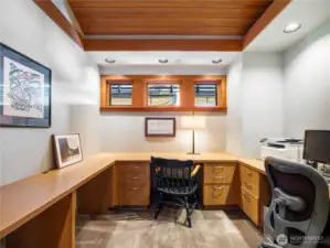 A well-appointed office with custom buil-in desks and storage creates a functional and stylish workspace