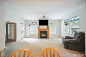 Family room with a fireplace so you can just sit and relax. Double doors lead into the living room and other door to your covered outside deck.