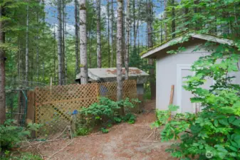 Storage shed with outside water spigot.