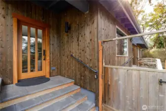 Terrace like entry, with beautifully trimmed door, custom hardware giving the feel of an authentic Genkan entryway.