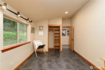 Large windows accent the guest suite, with an open closet space that encourages peace of mind and organization of space.