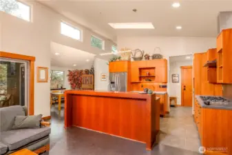 The kitchen is multi functional with eating space at the counter, flowing light, and space saving build ins.
