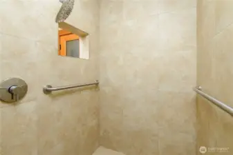 The executive spa room, offers a tranquil fully walk in shower, surrounded with neutral tone tile.