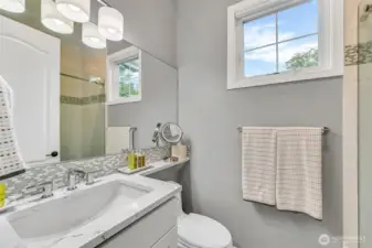 Remodeled guest bath in 2022 with a floor to ceiling tiled shower, custom shower door, Kohler shower head and undermount sink, Toto toiler, bathroom light fixture, and the cabinets were refaced and painted.