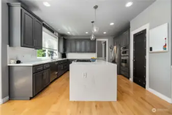 Large and bright kitchen. Walk in pantry is door to the right of island.