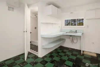 This space was previously used as a second kitchen. A three-quarter bath is behind the door.