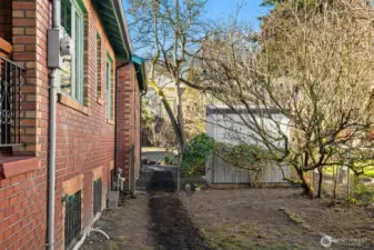 Looking from the front of the house to the back yard with the alley beyond.