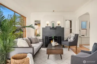 Original fireplace and lots of sunny windows make this living room so welcoming and comfortable.