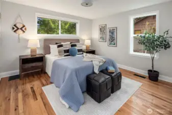 The primary bedroom has gorgeous wood floors and two closets!