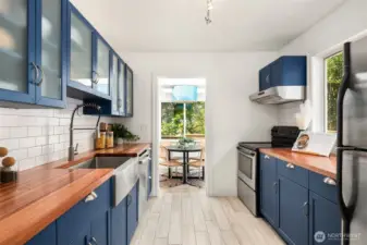 Kitchen with wood counters and stylish blue cabinets