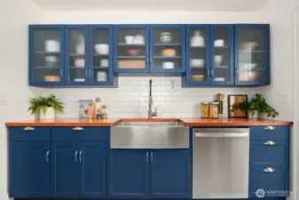 Kitchen cabinets with lots of storage and stainless steel sink and washer