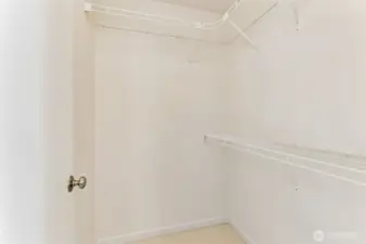 Huge primary walk-in closet with built-in shelving and room for more customization for new owners if desired