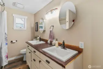 Main bathroom with tub/shower, toilet, double sink and linen storage (not in picture)