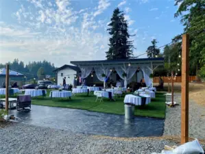 Back yard with turf, surrounded by lighting.  Perfect for a large party/ event or a casual game of volleyball any time of year, day or night.