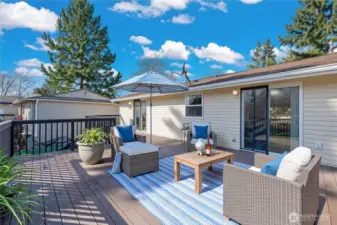 Entertainment size deck off the kitchen and primary bedroom is virtually staged