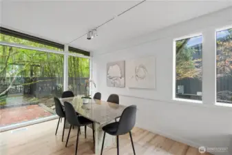 Spacious dining area connected to both kitchen and living spaces, offering great natural light and an open-concept feel.