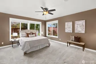 Generously sized primary suite tucked at the end of the house for relaxation and private enjoyment!