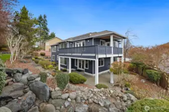 Mature landscape and a custom water feature grace the backyard.