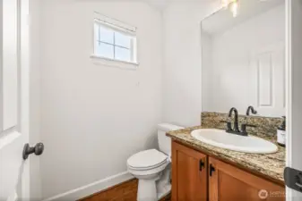 Powder room located on main great room level with new plumbing fixtures including new toilet and lighiting.