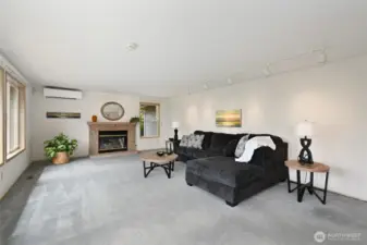 Family room features propane/wood burning fireplace, track lighting, A/C, and great views